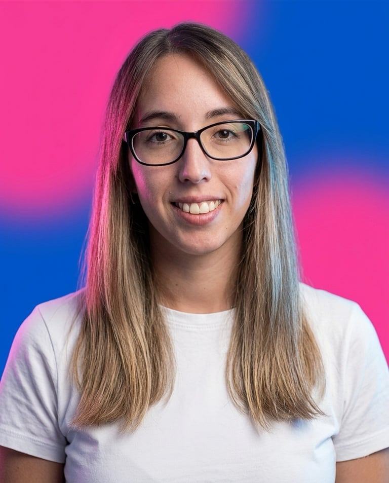 Smiling person with long brown hair and glasses wearing a white t-shirt against a pink and blue gradient background