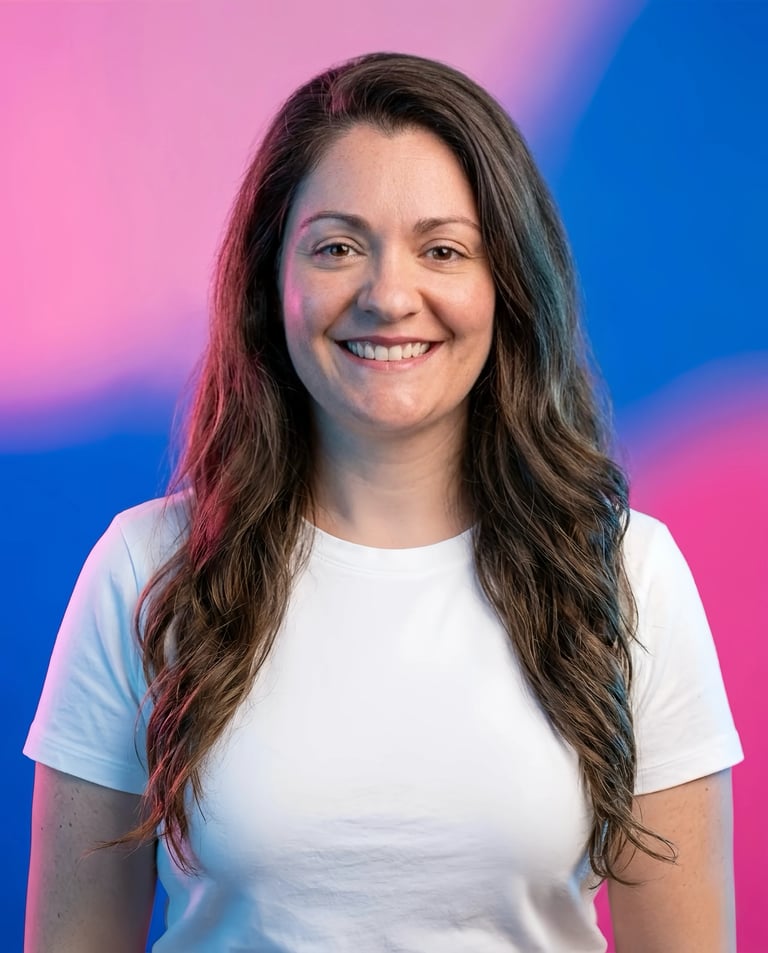 Portrait of a smiling woman with long dark wavy hair wearing a white t-shirt against a pink and blue gradient background